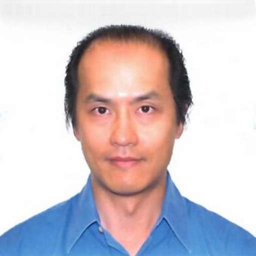 Man in blue shirt, neutral background.