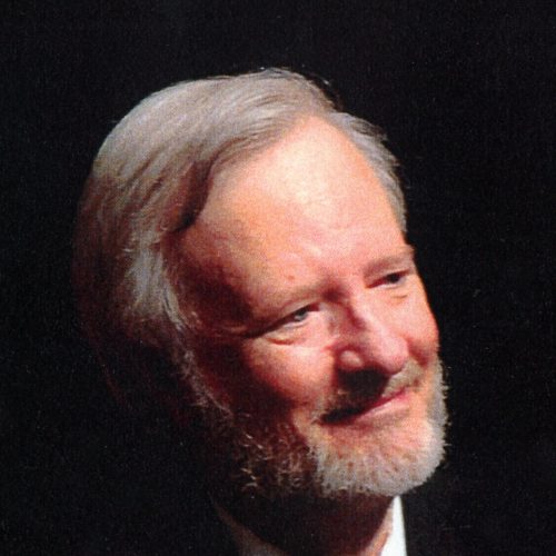 Older man with a beard and suit.